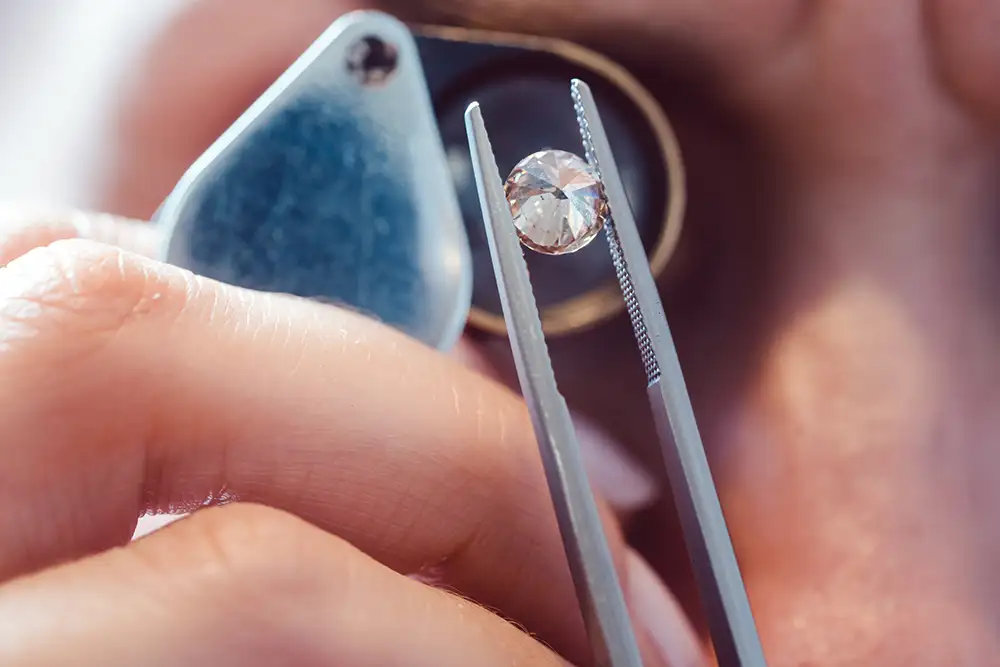 Gemologist inspecting a diamond with a loupe